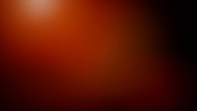 Soft orange light flare on dark red gradient background, abstract bokeh effect, concept for background overlays, transitions and website hero sections.