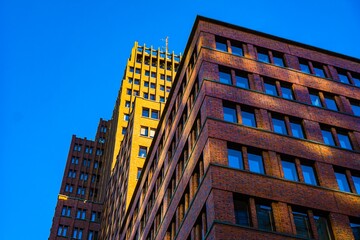 Fototapeta premium Modern brick buildings against a clear blue sky
