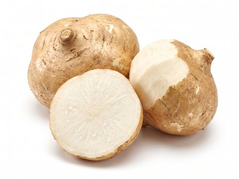 Fresh raw jicama root vegetable isolated on white background, showing whole tubers and a cut slice with crisp white flesh and light brown skin