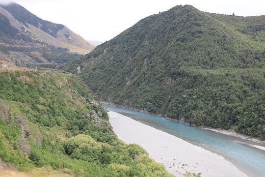 scenic alpine valley, turquoise-blue river, steep forested mountain slopes (wide-angle, panorama, moving-train-view) 6545