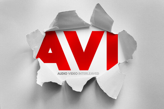AVI Audio Video Interleaved text shown through torn paper background, multimedia technology concept representing digital container format for synchronized media playback