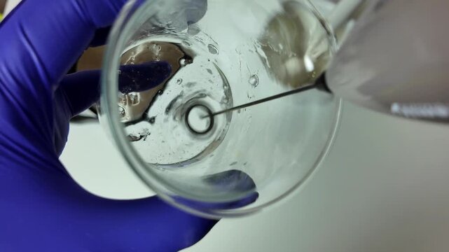Close Up of Liquid Mixing in Glass Beaker With Magnetic Stirrer