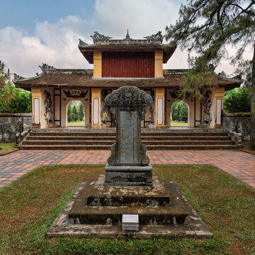 Stone stele in the courtyard of the historic Thien Mu Pagoda, featuring traditional Buddhist architecture and ornate details in Hue, Vietnam, under a bright sky