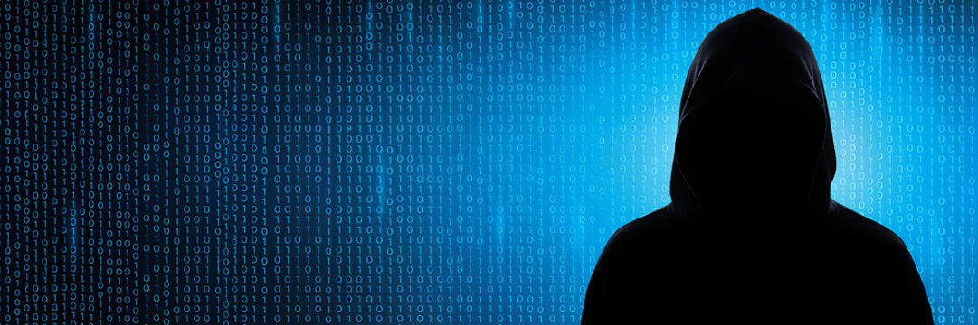 A mysterious hooded figure in silhouette against a glowing blue background, filled with vertical, streams of binary, code and digital information