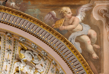Fototapeta premium CREMA, ITALY - MARCH 20, 2026: The fresco of angel with the music instrument in the church Santuario di Santa Maria della Croce by Giacomo Parravicino from year 1702