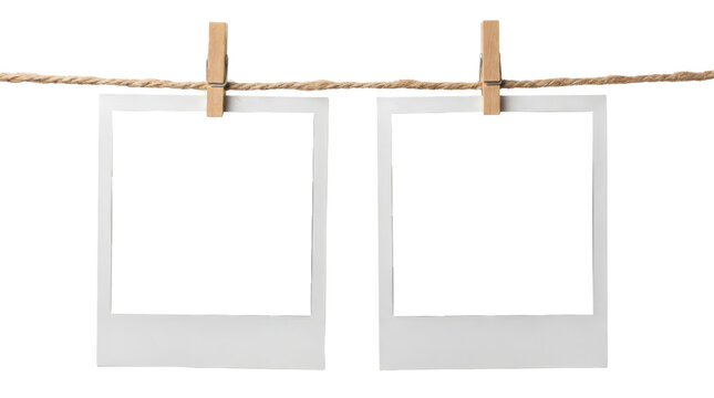 Vintage white photo frames hanging on string, set of two blank polaroid style film borders with wooden clips, retro paper picturedesign elements for scrapbooking isolated on transparent background