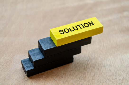 Yellow and black wooden blocks representing innovative solutions, strategy, and problem resolution.