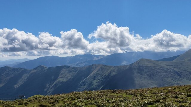 Dramatic Clouds Rolling Over Mountain Ridge
