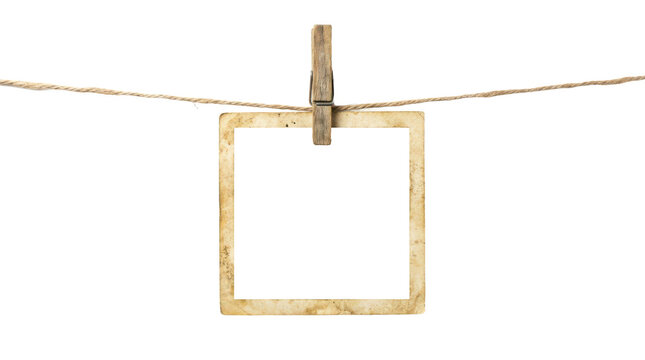 Vintage photo frame hanging on twine string, old paper picture border held by wooden peg, retro instant photo frame for scrapbooking albums isolated on transparent background