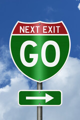 Go Next Exit text on an American interstate road sign with sky for next steps © Karen Roach