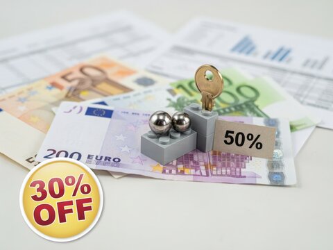 Conceptual Financial Image Showing Euro Banknotes With Discount Percentages And Metal Keys