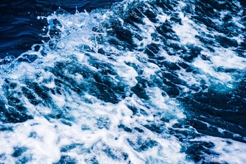 Obraz premium Abstract ocean wave with white foam and blue water
