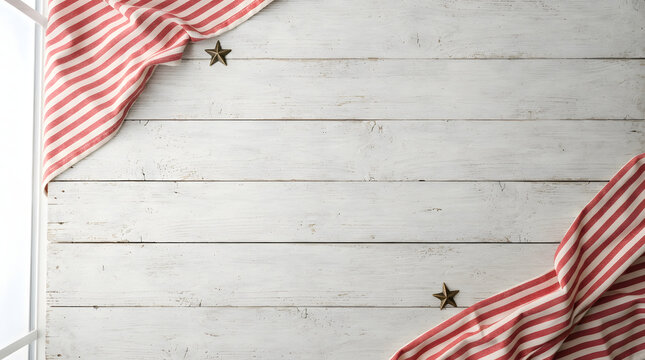 Red and white striped fabric on a rustic white wooden background with copy space