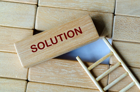 Wooden blocks labeled solution representing strategic problem solving and practical decision making.