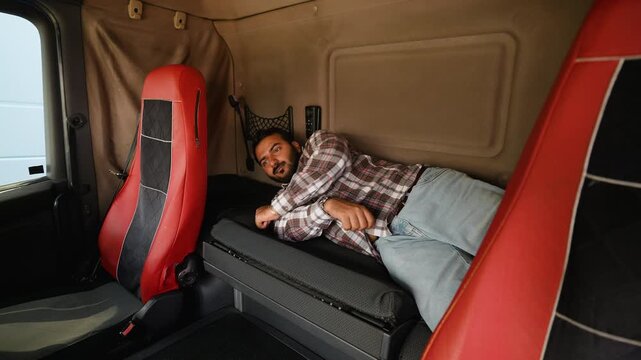 Truck driver waking up refreshed in sleeper cab