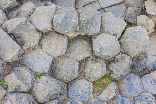 Natural grey stone pavement texture with hexagonal joints. stone wall texture