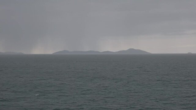 View from a ferry crossing the Gulf of Thailand toward Koh Samui with Mu Ko Ang Thong National Marine Park islands visible in the background under heavy monsoon in Surat Thani, Thailand