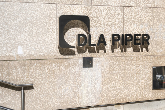 Toronto, Ontario, Canada - October 6, 2025: DLA Piper (Canada) law firm logo sign at the entrance to the office in downtown Toronto, Ontario, Canada. DLA Piper is a global law firm. 