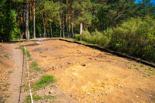 Archaeological excavation site near Tomskaya Pisanitsa in Siberia. Excavated soil layers represent research and discovery of ancient human history