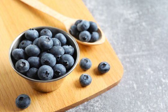 Bowl with fresh blueberries on the table, space for text