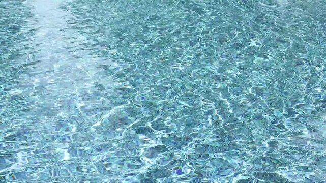 Swimming pool with blue crystal clear water surface and ripple wave background