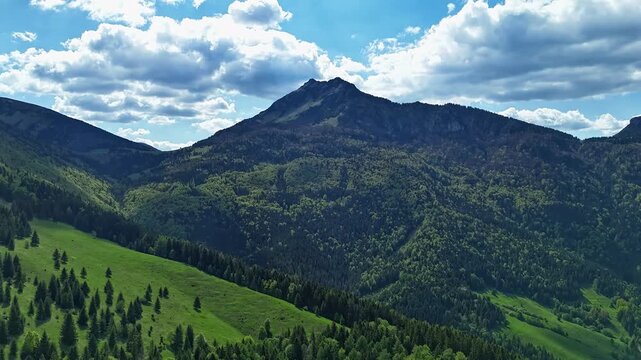 Aerial Hyperlapse Flying Forward Towards Majestic Mountain Peak Under Blue Sky