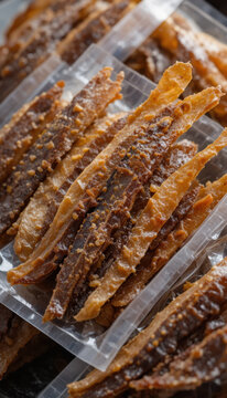 Deliciously crispy fish snacks are neatly packaged, showcasing golden brown color and crunchy texture. These treats are perfect for snacking, offering savory flavor that delights palate