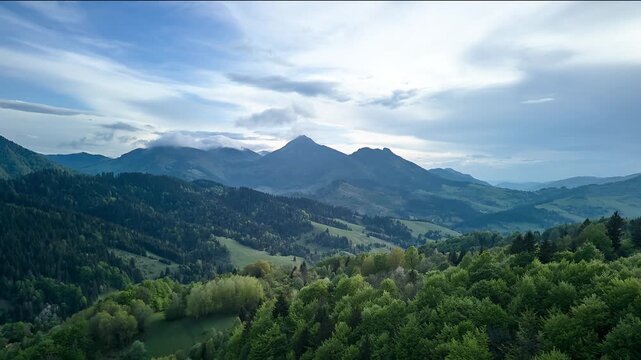 Aerial Hyperlapse Flying Backward Revealing Majestic Mountain Range And Valley