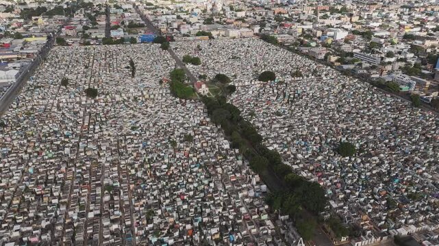 Wide aerial drone shot of massive urban cemetery dense with tombs in Santo Domingo