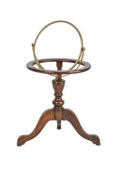 Antique brass armillary sphere on a dark wooden tripod stand, captured with soft studio lighting against a clean white background