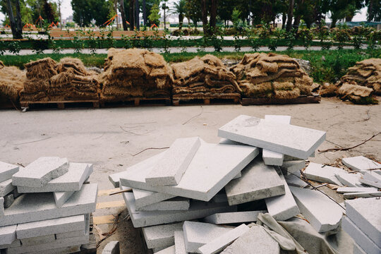 Stacked Paving Slabs and Straw Mats on Pallets