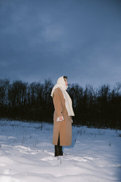 Woman Standing in Snow Field