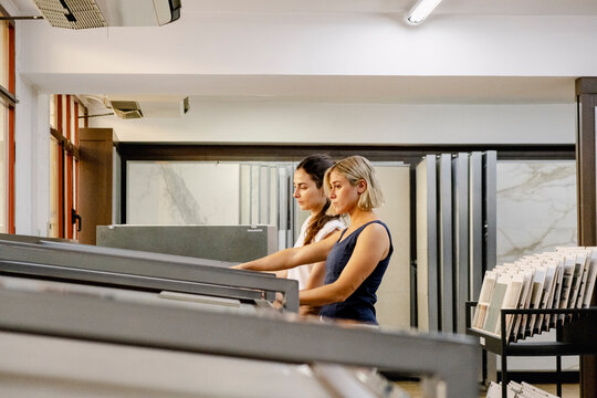Women reviewing surface samples for interior design project
