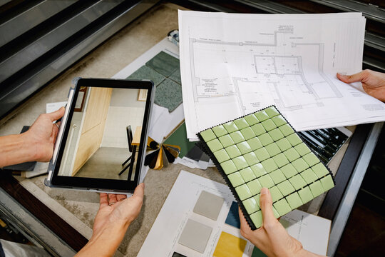 Anonymous Architect planning tile design with samples and tablet