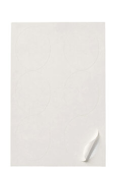White rectangular sheet of blank round stickers with one corner peeled back, isolated on a white background