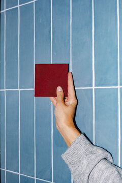Designer comparing tile color for bathroom renovation