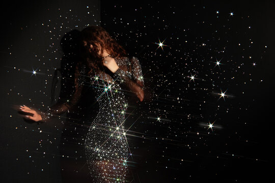 Festive glitter and sparkles around woman in a crystal gown, New Year holiday party concept.