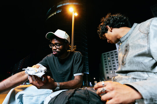 Friends Sharing Takeaway Food at Night