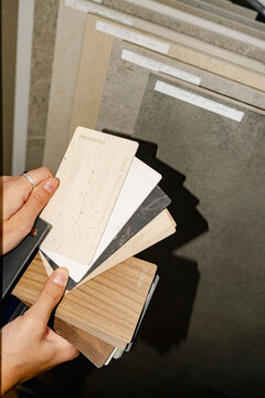 Hands comparing material samples for renovation project