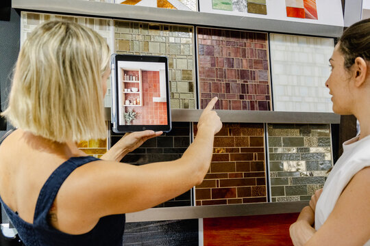 Interior designer showing tile options to renovation client