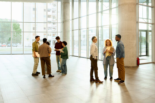 Students are consulting, standing in the lobby