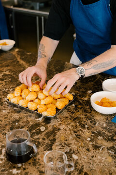 Close-up of a chef plating a gourmet dish in a luxury kitchen