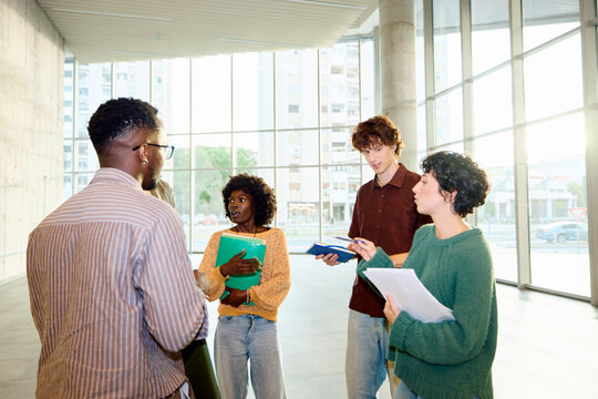 Few students chat in the lobby