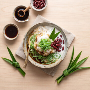 Layered Iced Cendol Drink with Coconut Milk and Palm Sugar on White Background