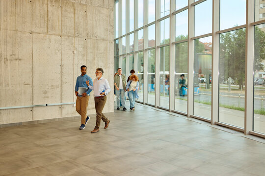 University staff walk through the hallway