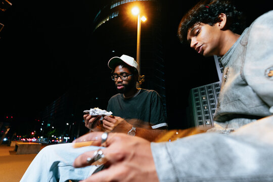 Friends Eating Takeaway at Night