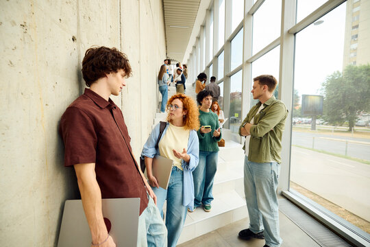 Students Communicate in a Modern University Building