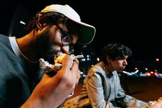 Friends Eating Takeaway at Night