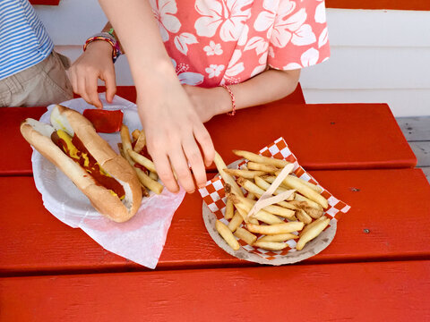 Two girls having hot dogs and fries