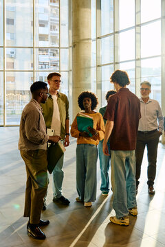 Group of students exchange their experiences in the lobby